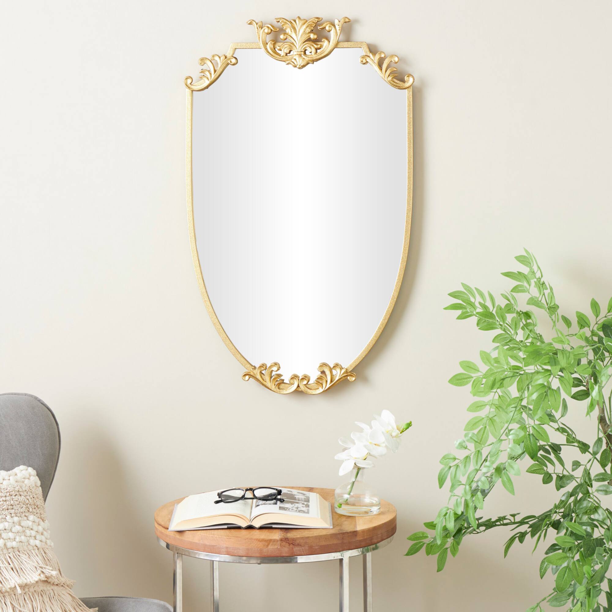 21" x 34" Gold Metal Shield Wall Mirror with Floral Embellishment